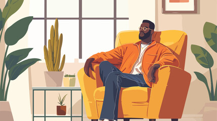 Handsome African-American man sitting in armchair 