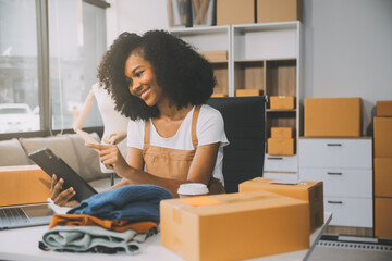 Startup SME small business entrepreneur of freelance Asian woman wearing apron using laptop and box...