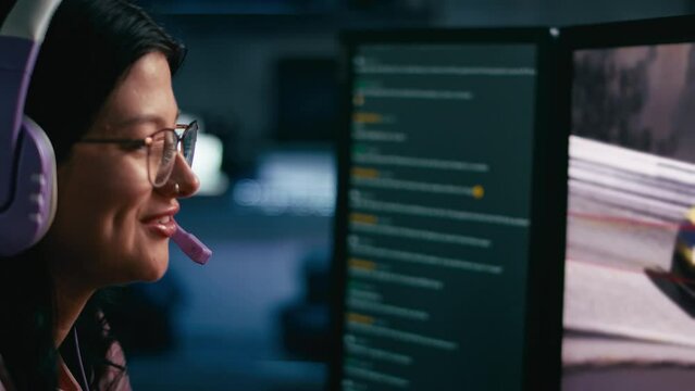 Close up of female gamer wearing headset plying online racing game at night  - shot in slow motion