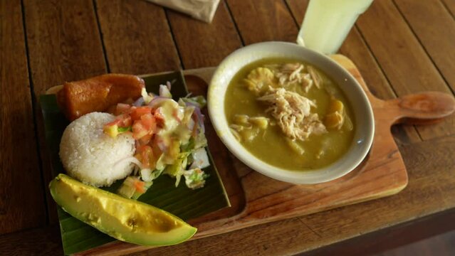 Colombian Ajiaco Soup Served with Rice, Salad, Plantain and Avocado. Close Up