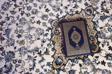 Top view Al-Quran on prayer mat