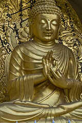 golden colored statue of lord Buddha engraved in a monastery in darjeeling in india