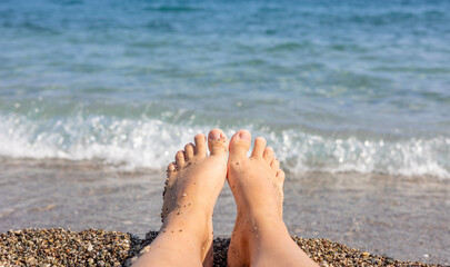 woman girl feet on beach against sea. steps on sands. relax in summer vacation concept. 