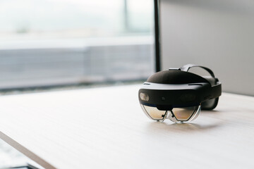 A VR headset placed on a desk, representing the integration of cutting-edge technology in a...