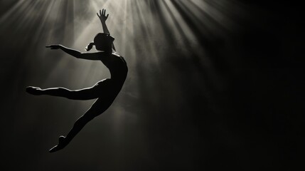 Ballet dancer in silhouette performing a leap, dramatic contrast lighting