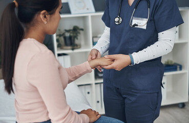 Doctor, hands and young patient with checkup for arthritis, wrist pain or injury at hospital. Closeup of medical employee, nurse or cardiologist monitoring arm for beat, pulse or joint ache at clinic