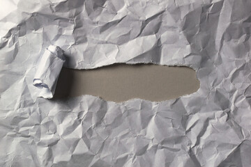 A sheet of crumpled paper with a window for text