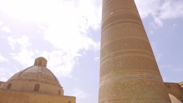View of Kalan Minaret Emir and Alim Khan madrasah of Po-i-Kalan (Poi Kalan) -Translation: "Poi Kalan islamic religious complex" Bukhara, Uzbekistan