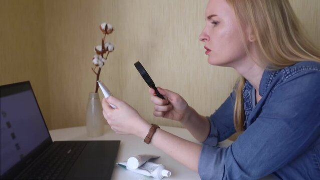 Toothpaste ingredients. Girl checks composition of toothpaste and is surprised by dangerous composition of product. Emulsifiers, preservatives, dyes, PEG, SLS, parabens, diethanolamine