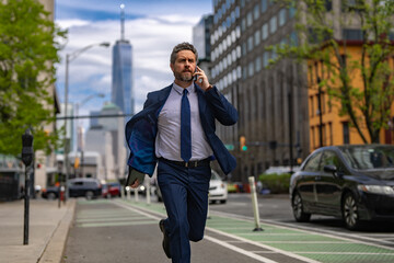 Man in suit with phone run in NY. Business talk. Businessman run down street talking on the phone....