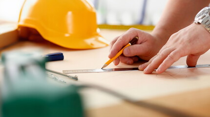 Arms of worker making structure plan on scaled paper closeup. Manual job DIY inspiration...