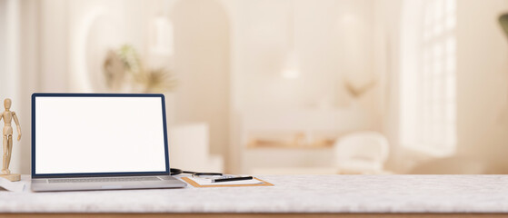 A doctor's office desk features a laptop computer on the desk in a modern luxurious clinic lounge.