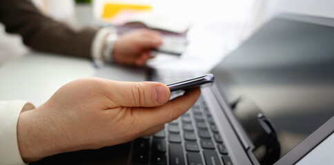 Male arms hold credit card press buttons making transfer closeup. Anti-fraud financial security when entering client discount program number or filling personal credential password login to account