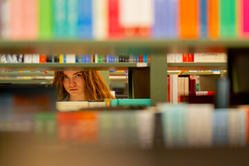 close up in a bookstore young girl chooses a new book for herself preparing for exams