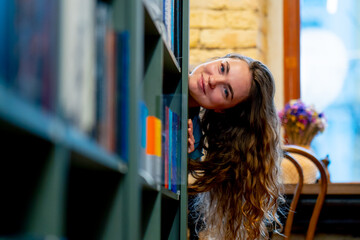 close up in a bookstore young girl chooses a new book for herself preparing for exams