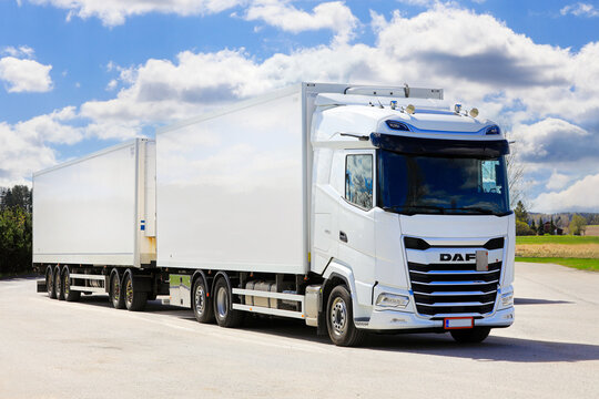 New, white DAF XG 530 truck double trailer parked at truck stop on a beautiful day of spring. 