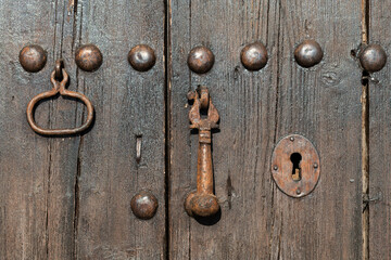 Detail of an old, weathered, textured wooden door.