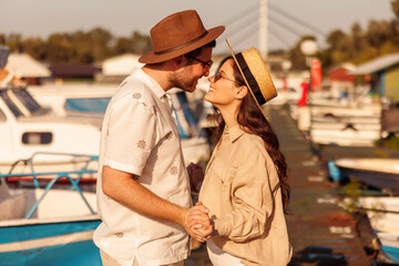 Couple kissing while relaxing by the river on hot summer day