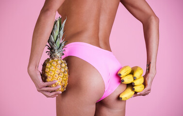 Sexy Summer. Summer beauty sexy woman butt with banana and pineapple. Summer sexy fruits.
