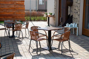 Tables and chairs in the courtyard of a private house. Nobody inside
