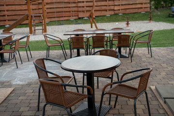 Outdoor coffee terrace with tables and chairs in a summer day