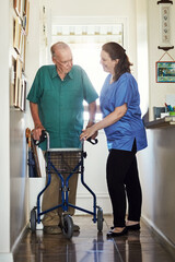 Senior man, walker and help with nurse for physiotherapy, healthcare or trust at old age home. Woman, medical caregiver or volunteer talking to person with a disability in retirement for support