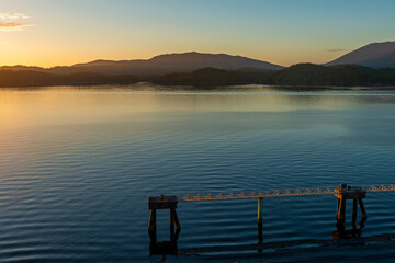 Pipeline with dock for industrial transport in harbor of Prince Rupert at sunset, British Columbia, Canada.
