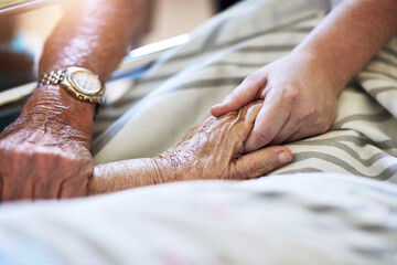 Elderly person, hands and visit with hospital, closeup and senior care or love together. Elderly...