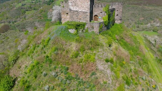 Historic Doiras Castle On The Green Hill On A Sunny Day In Cervantes, Spain. - aerial shot