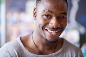 Smile, portrait and black man at cafe to relax, cheerful and positive face for leisure at...
