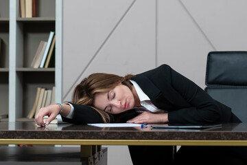 Tired frustrated and overworked business woman sitting in the office and thinking about problems in business