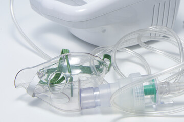 A clear plastic mask with a green cord attached to it