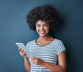 Studio, black woman and digital tablet in portrait to chat, connect and social media with smile. Blue background, girl and tech for networking, scrolling and typing or read by online application