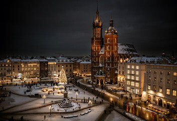 Main Square (Saint Mary's Basilica) in Krakow during blue hour at magic dusk during Christmas time and winter, Poland