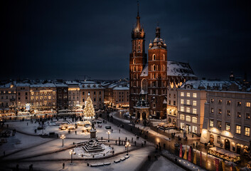 Main Square (Saint Mary's Basilica) in Krakow during blue hour at magic dusk during Christmas time and winter, Poland
