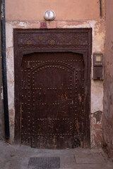 entrance wooden old carved doors Morocco in oriental style, traditional oriental shades, ornate...