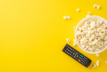 Enjoy home cinema with premieres via TV app. Top view of tasty popcorn and remote for online...
