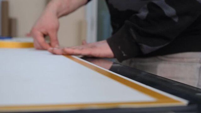 Person applying double sided tape.