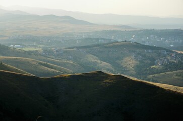 Fototapeta premium Green hills with town buildings in the distance. Zlatibor, Serbia