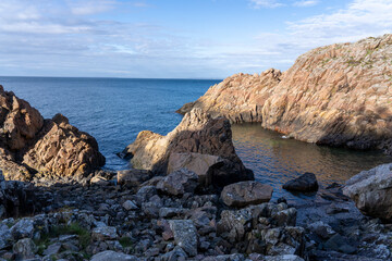 Picturesque coastal landscape featuring rocky terrain and lush grassy vegetation in Varberg, Sweden
