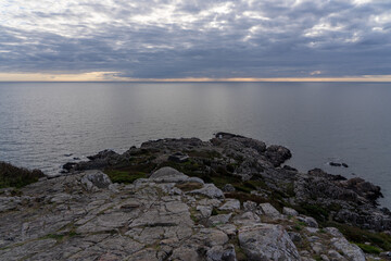 Scenic seascape featuring a rocky shoreline, with wispy clouds gathering in Varberg, Sweden