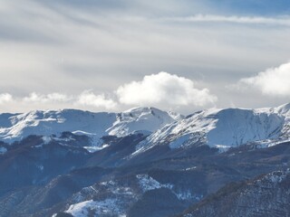 a skier is skiing in the snow in front of snow capped mountains