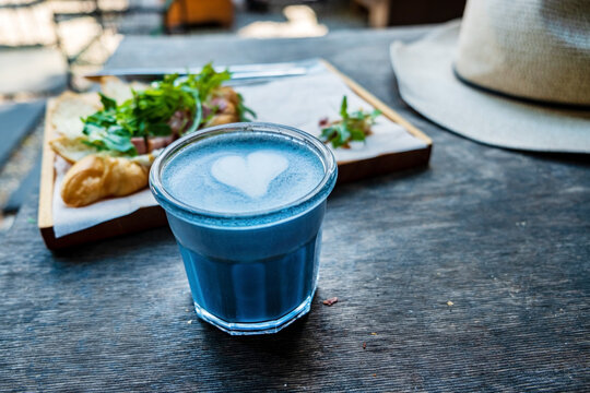 Blue matcha latte coffee with milk foam.