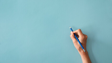 Woman hand are writing on blue background