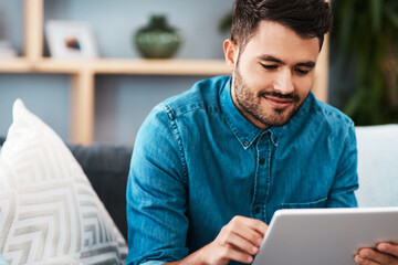 Businessman, tablet and happy working from home for remote job, internet search or social media. Male person, smile and confident on sofa with technology for graphic design or online communication
