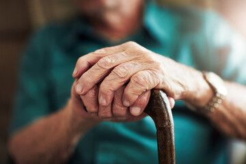 Senior man, hands and support with cane for old age, osteoporosis or care in retirement home....