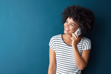African woman, phone call and smile in studio by space for mockup, thinking or contact by blue...