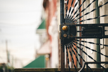 a close up of a gate with an ornate wheel on top
