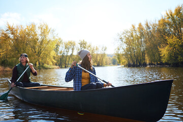 Couple, canoe and lake rowing in wood for exploring nature or teamwork for healthy morning, travel...