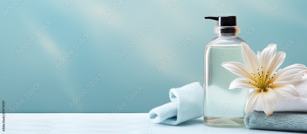 Aufkleber top view of a light blue background with a bottle of liquid soap a towel and a flower there is copy 